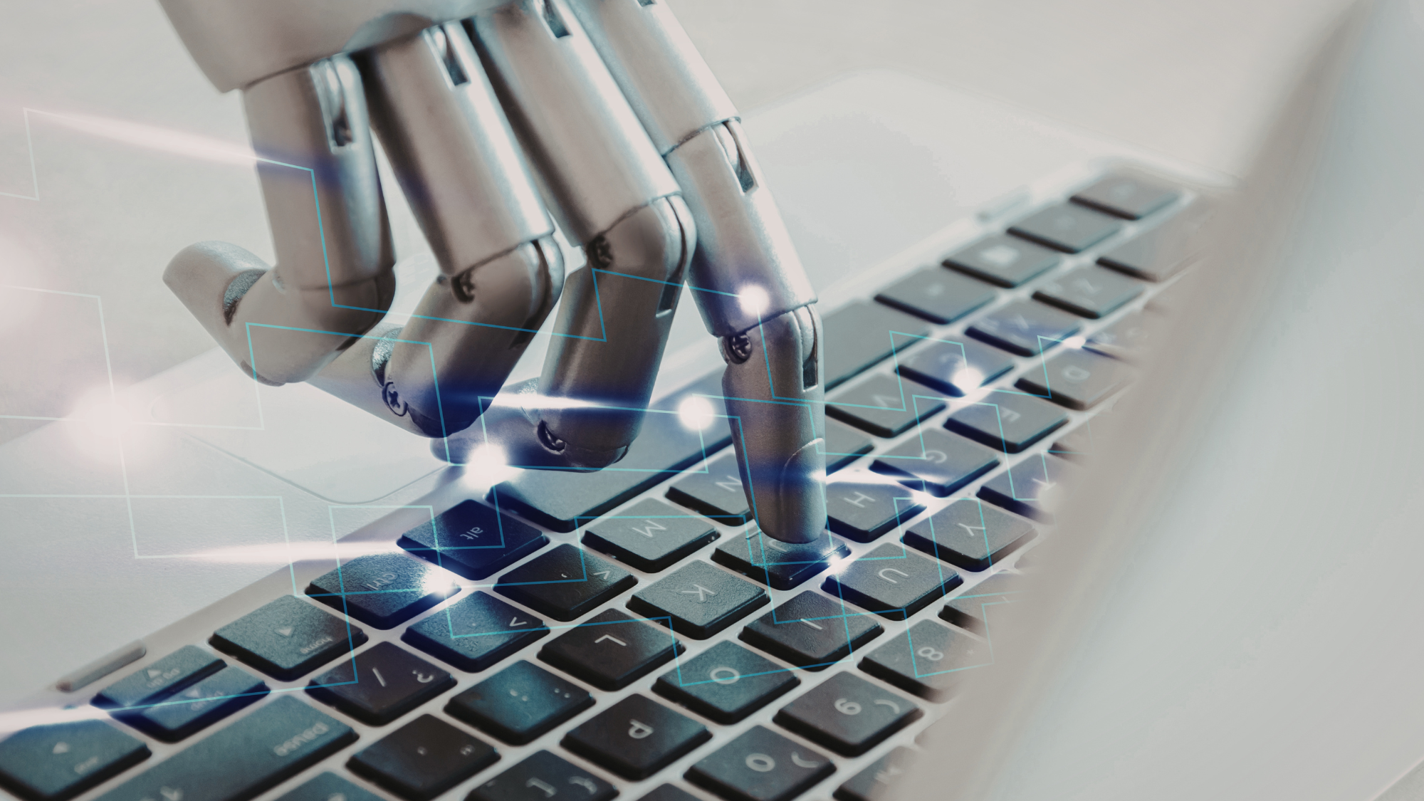 A robot hand touching a computer keyboard symbolizing automation.