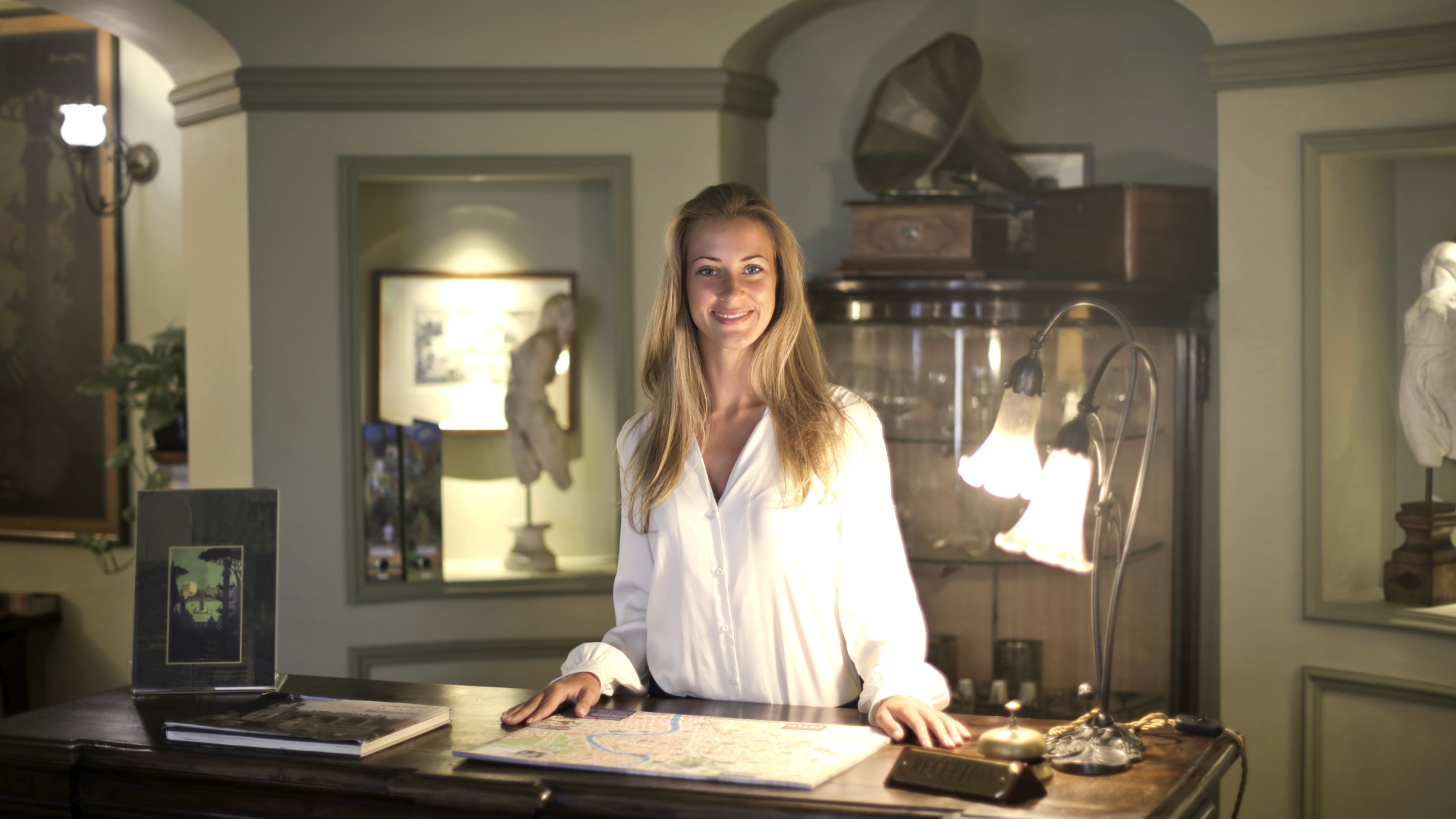 Photo of a property manager at a boutique hotel reception, symbolizing Jurny’s AI transforming vacation rentals into scalable, enterprise-level operations.